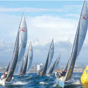 sailboats rounding a yellow mark